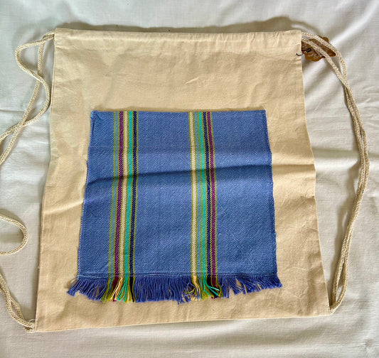 Drawstring canvas backpack with handwoven pocket