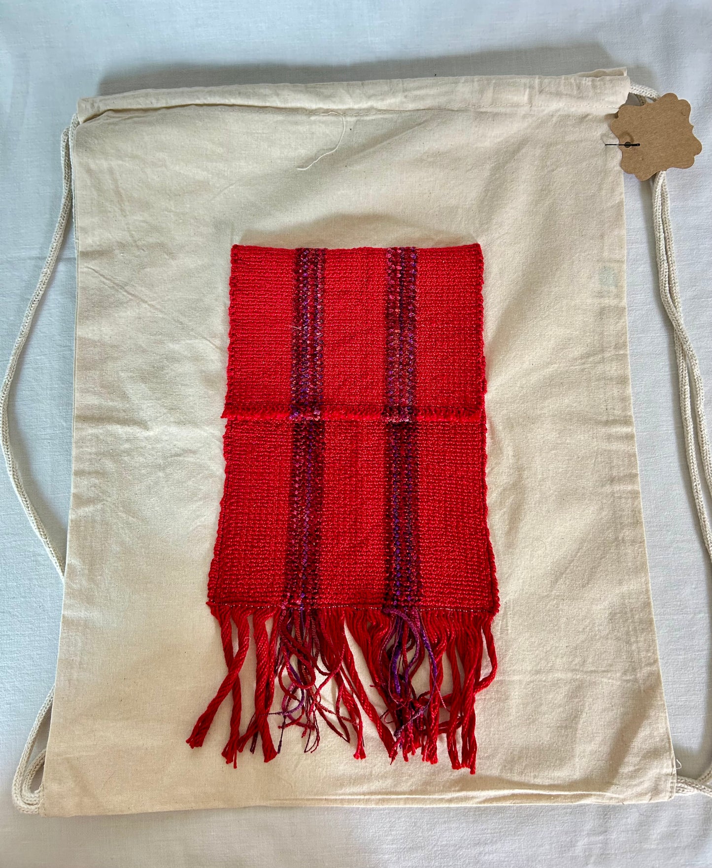 Drawstring canvas backpack with handwoven pocket